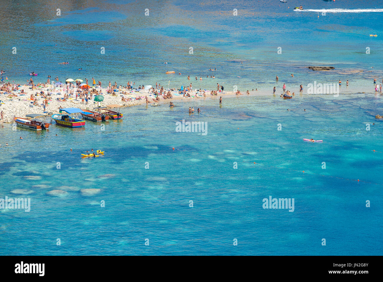 Mazzaro beach Sicily, view in summer of Mazzaro beach, a popular location near to Taormina for those keen to sunbathe or swim, Sicily. Stock Photo
