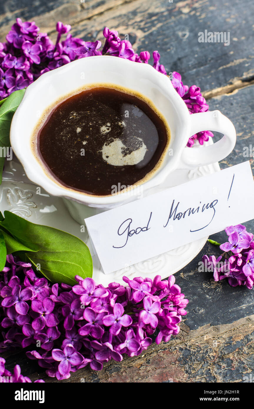 https://c8.alamy.com/comp/JN2H1R/cup-of-morning-coffee-and-purple-lilac-flowers-on-dark-wooden-background-JN2H1R.jpg
