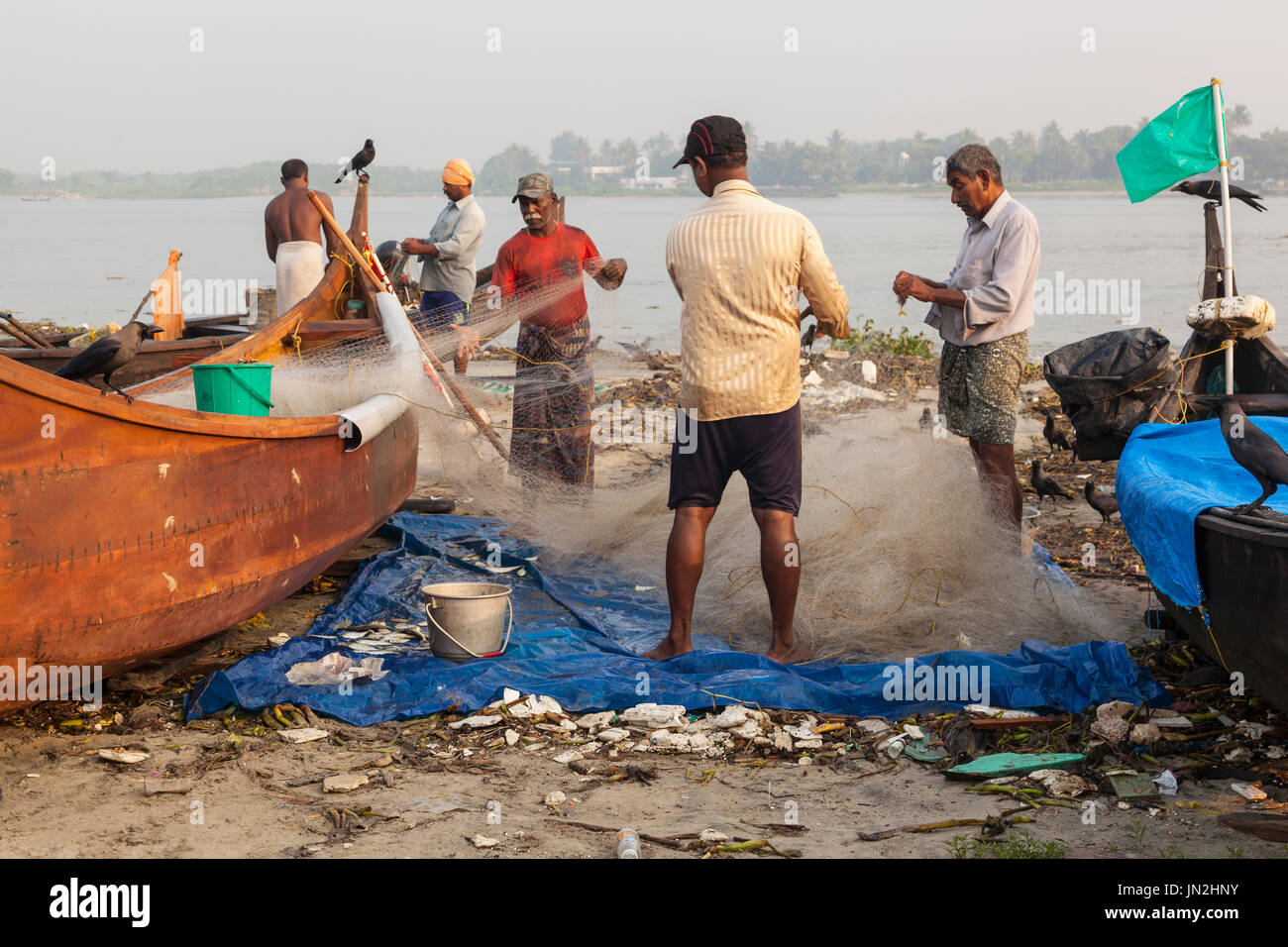 Fishermen in Fort Cochin at dawn, Kerala, India Stock Photo