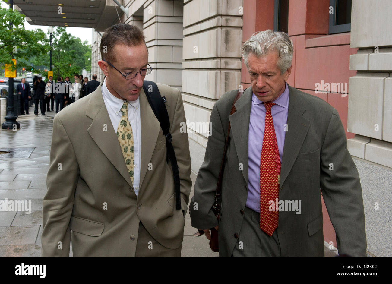 Brian McNamee speaks with an unidentified person as he departs U.S