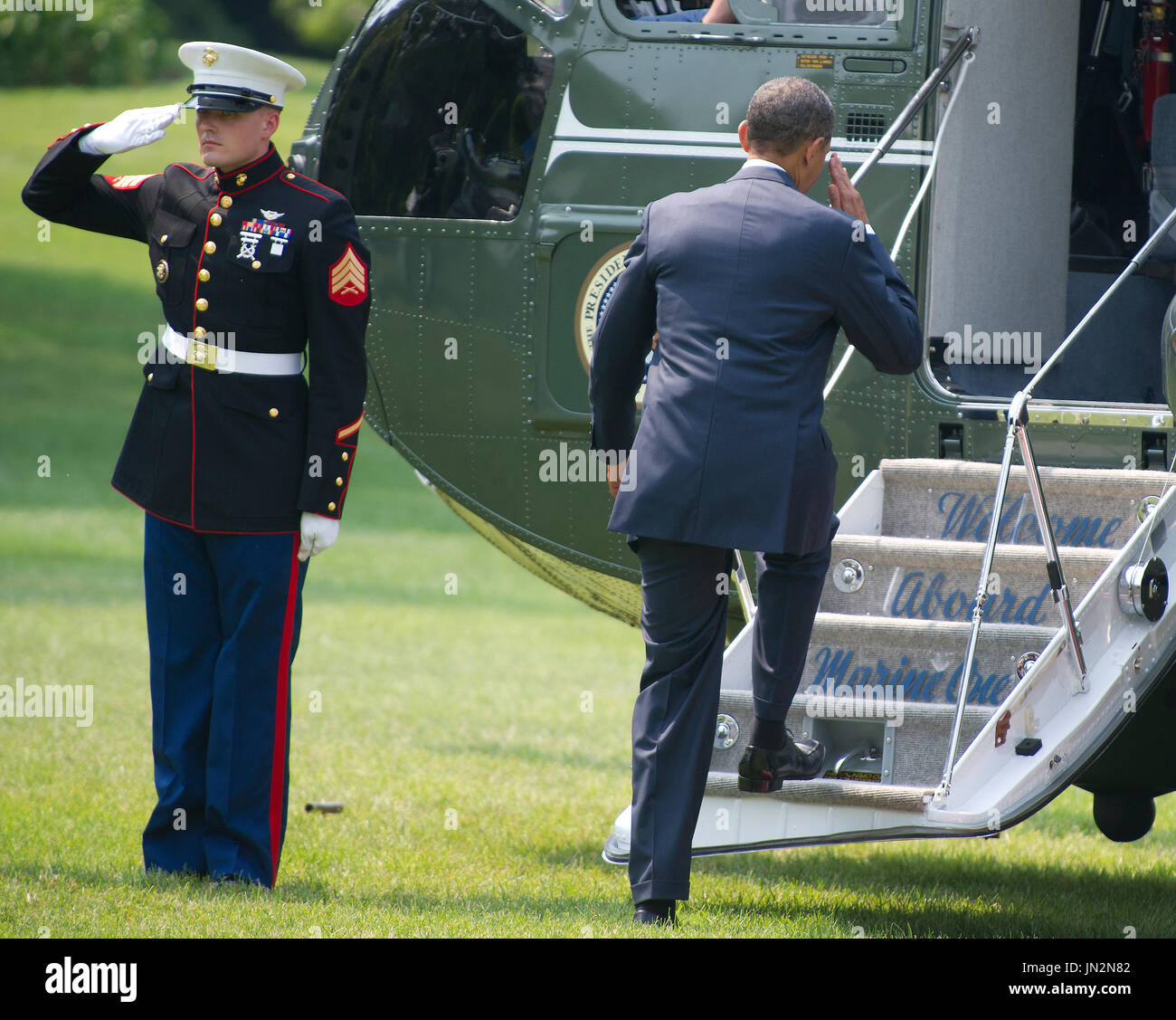 United States President Barack Obama salutes as he boards Marine 1 on ...