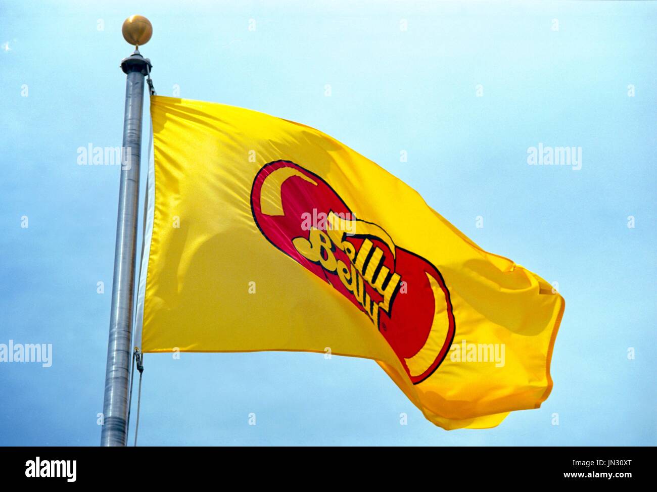A yellow flag with the Jelly Belly Candy Company logo flies at the Jelly Belly Candy Company factory in Fairfield, California, June 7, 2017. Stock Photo