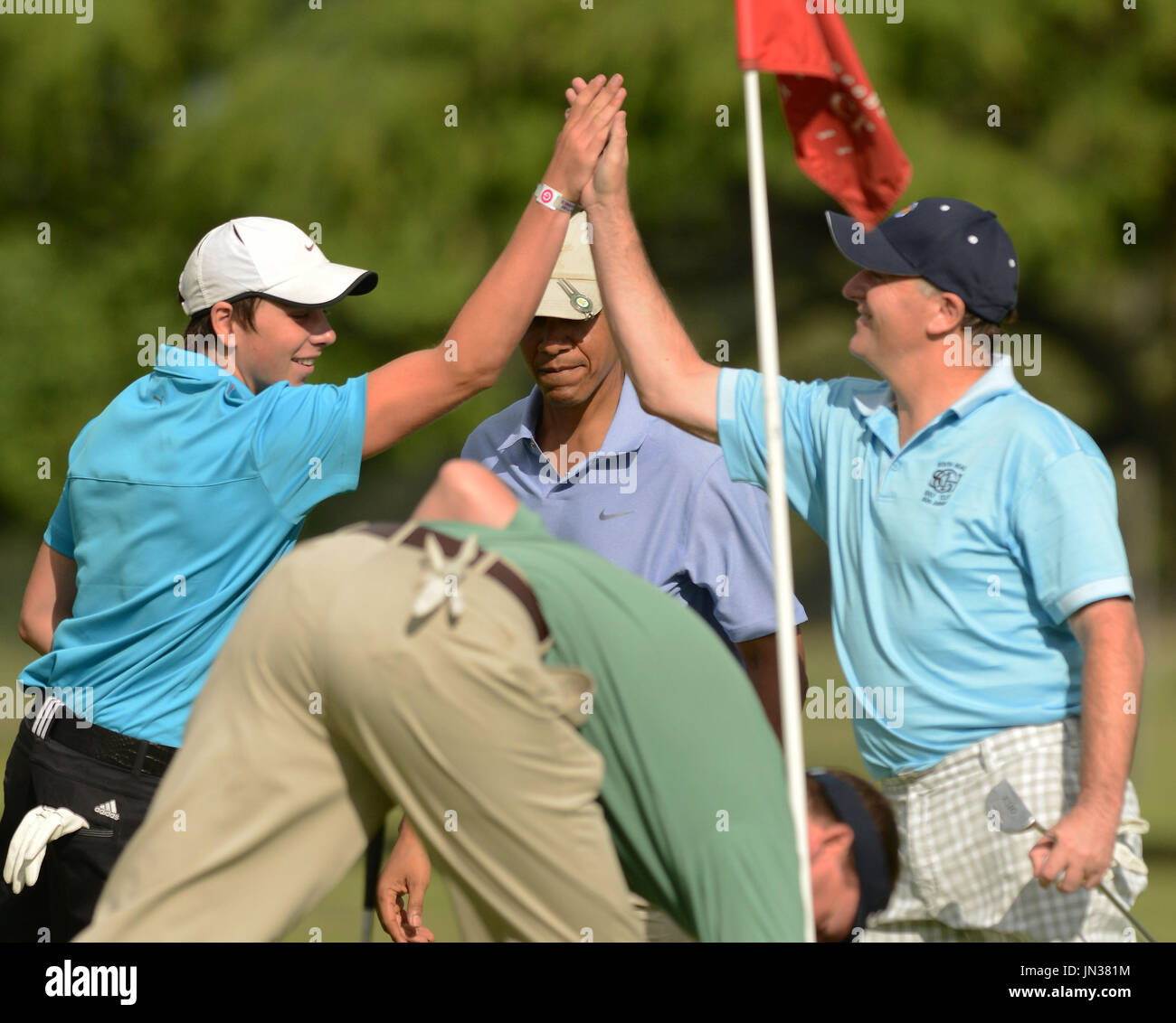 Prime Minister John Key of New Zealand, right, high fives his son, Max ...
