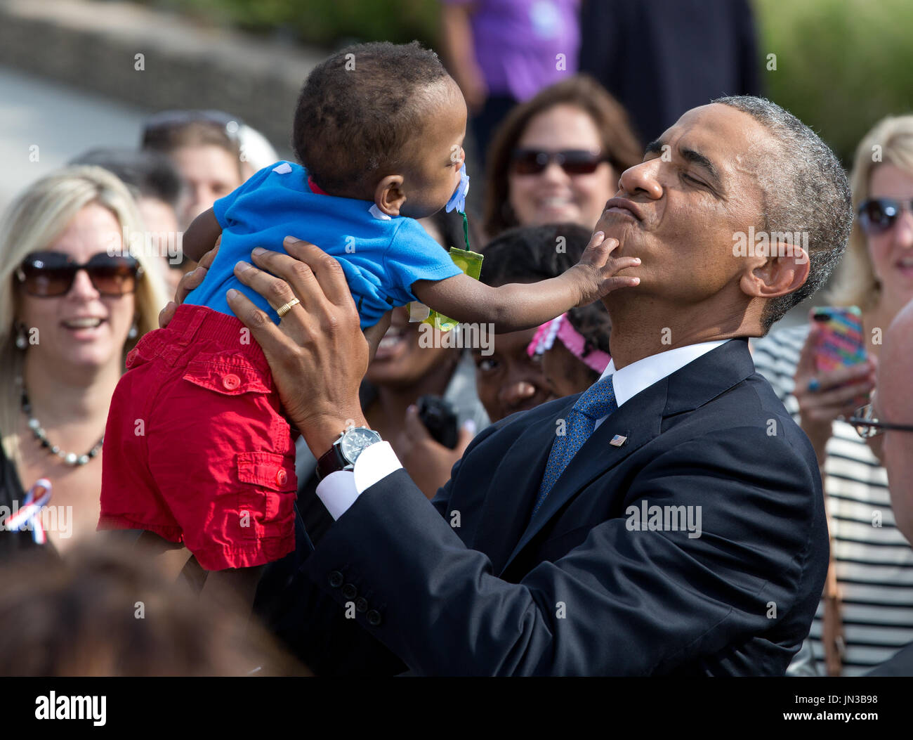 United States President Barack Obama holds up Larnell Maurice Perry, Jr. (13 months) during a ceremony at the Pentagon to mark the 13th anniversary of the September 11th, 2001 terrorist attacks, in Washington, Thursday, September 11, 2014. The boy is the grandson of Angeline C. Carter, who died in the Pentagon attack on September 11, 2001. Credit: Martin Simon / Pool via CNP Stock Photo