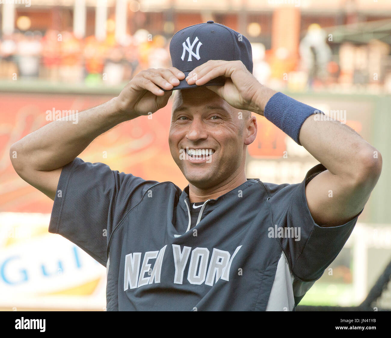 New York Yankees shortstop Derek Jeter (2) smiles as he adjusts his cap ...