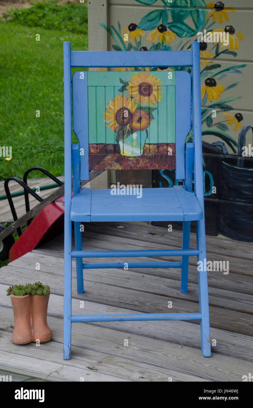 Painted blue chair on porch of painted shed, Yarmouth Community Garden, Maine, USA Stock Photo