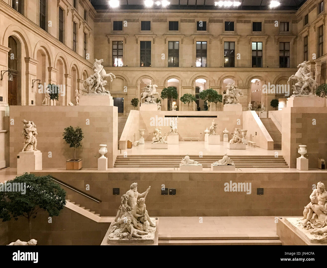 Marble statues in an empty Louvre Museum at night in Paris, France