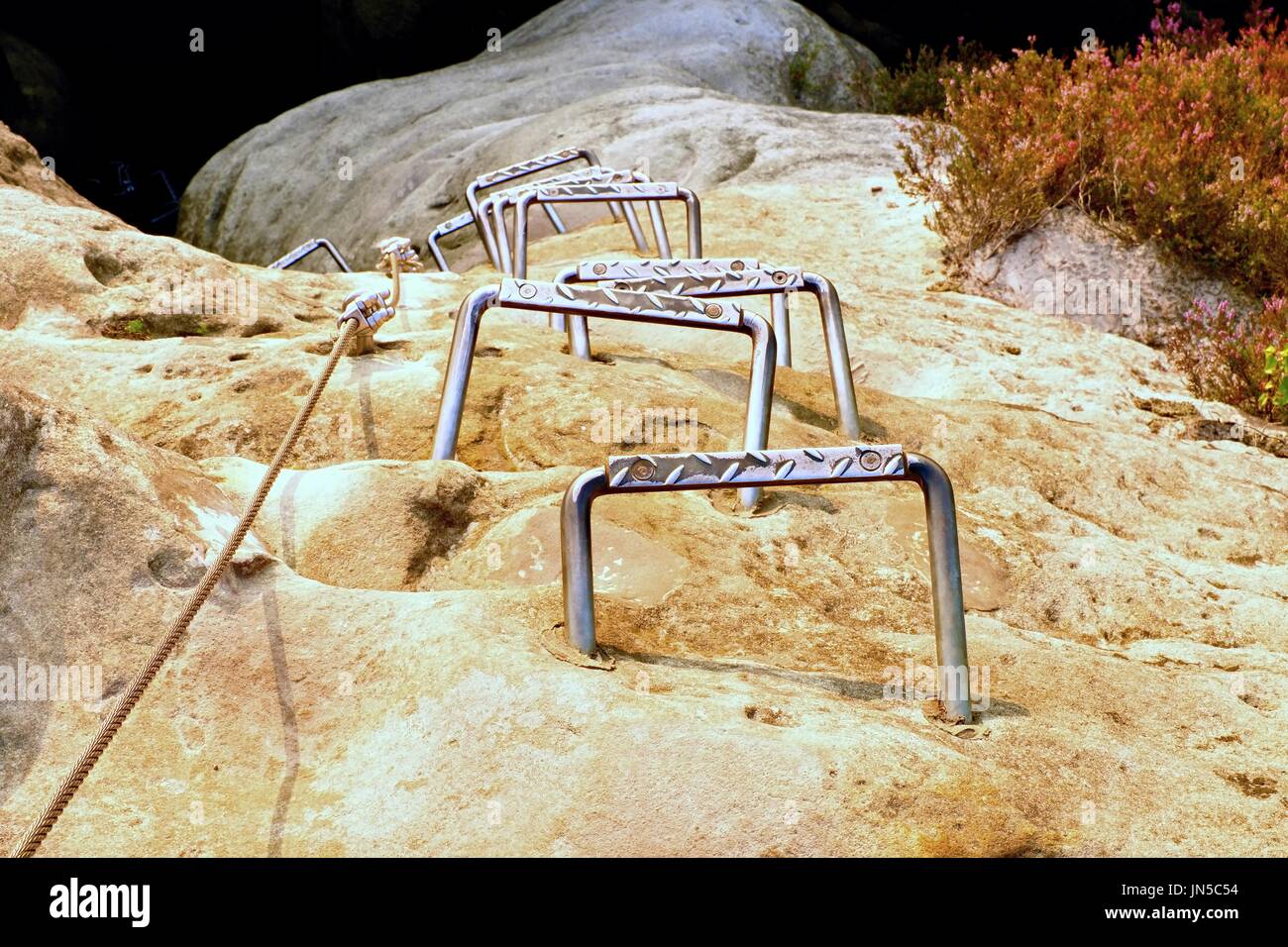 Climbers ladder. Iron twisted rope fixed in block by screws snap hooks