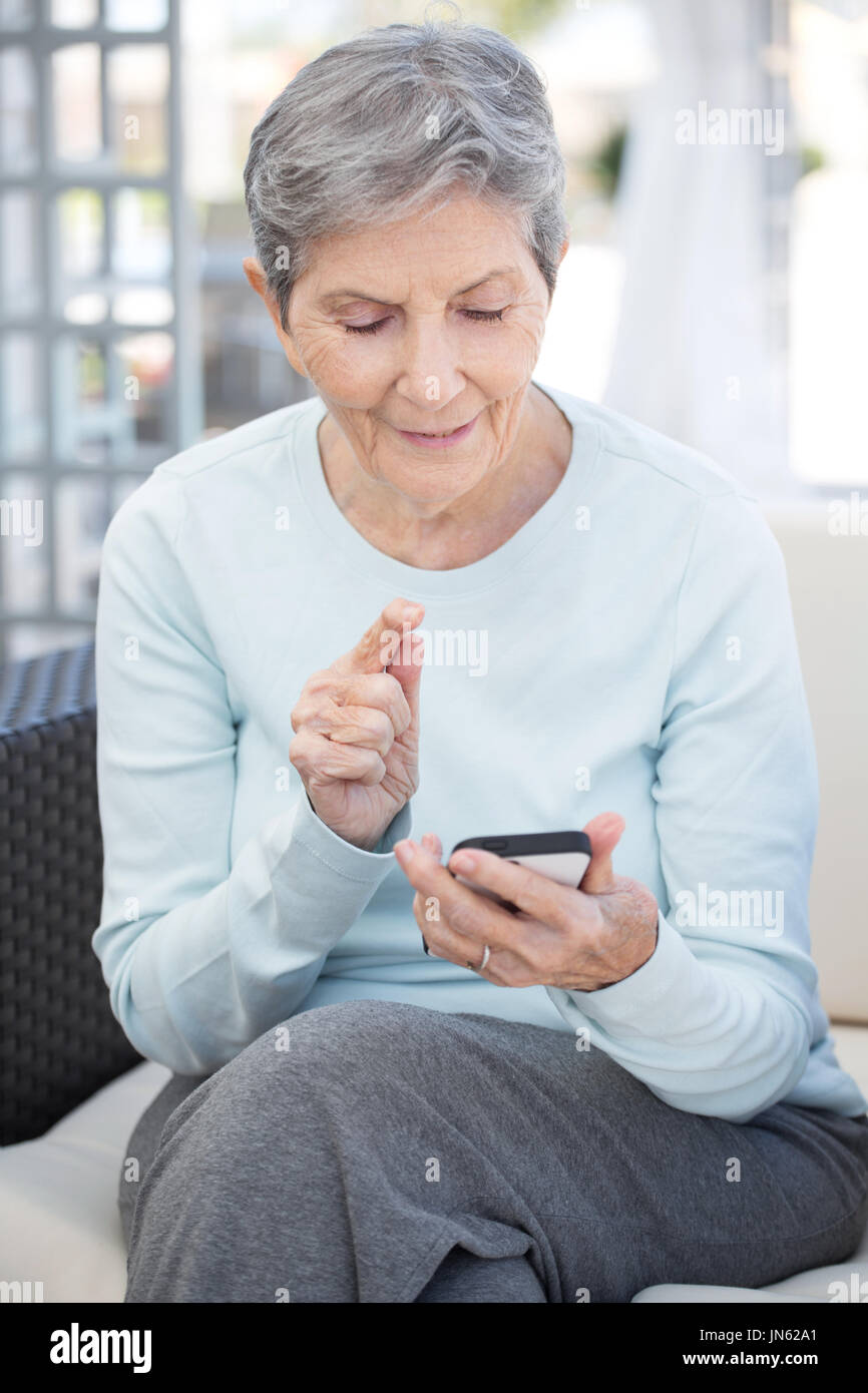 Elderly woman texting and typing. Stock Photo
