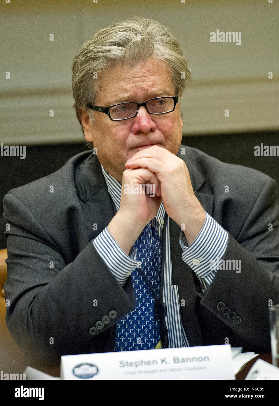 Stephen K. Bannon listens as United States President Donald Trump
