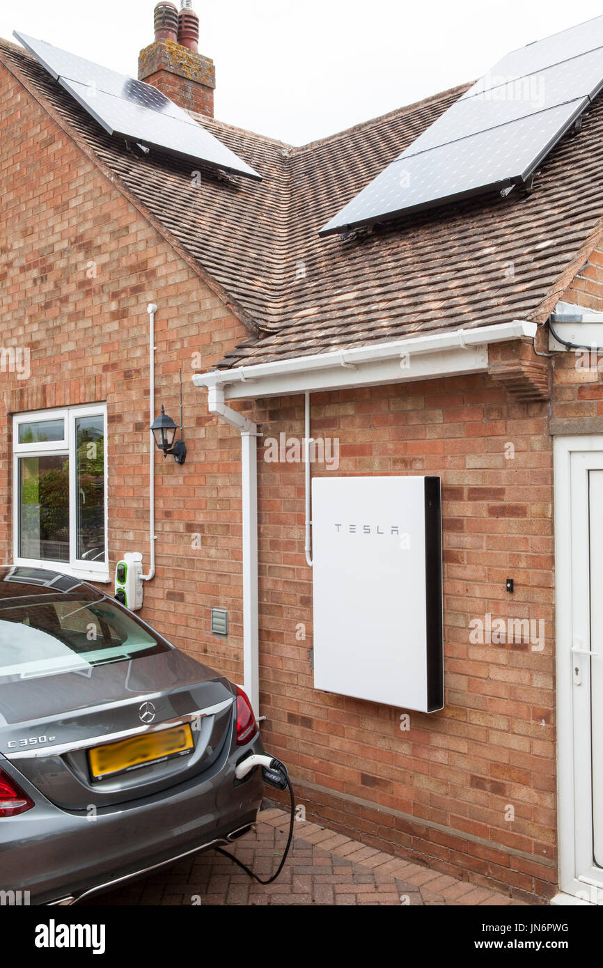 A Mercedes C class Hybrid electric car being charged ( via a Rolec charger) from solar PV stored in a Tesla Powerwall 2, a 14kWh battery.  All done fr Stock Photo