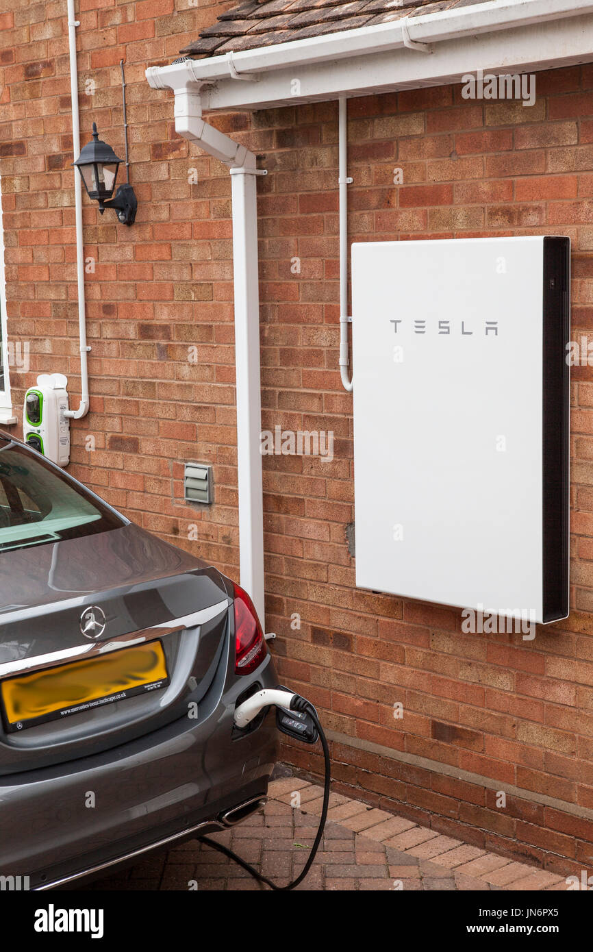 A Mercedes C class Hybrid electric car being charged ( via a Rolec charger) from solar PV stored in a Tesla Powerwall 2, a 14kWh battery.  All done fr Stock Photo