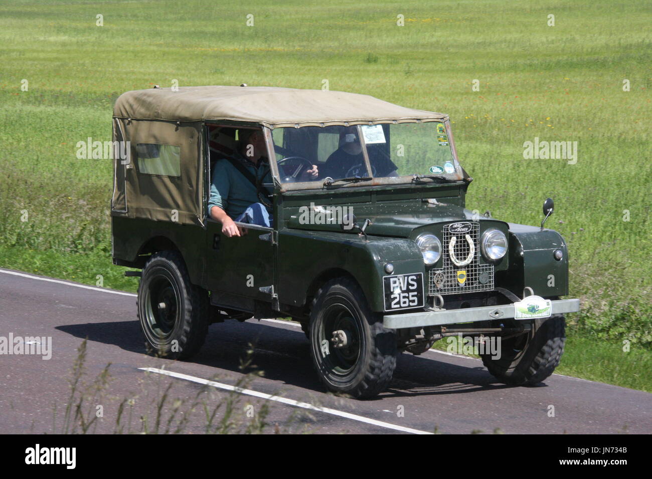 A SUNNY LANDSCAPE VIEW OF A LAND ROVER SERIES 1 ON A CLASSIC EVENT ...