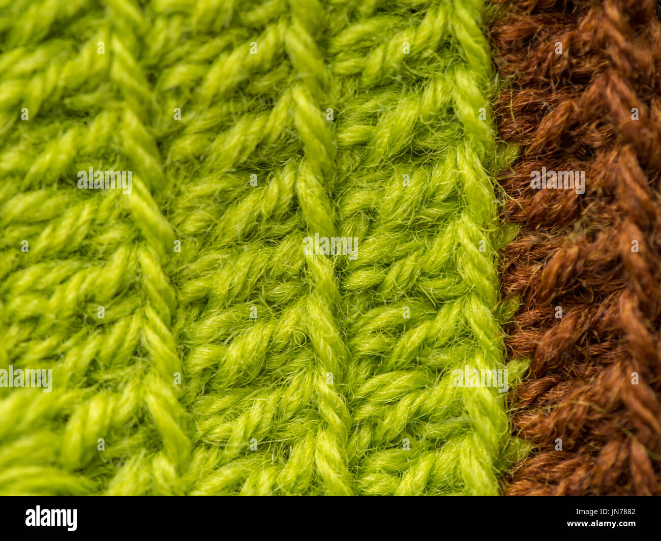 A beautiful closeup of a hand made crochet pattern of a colorful wool yarn. Soft and warm natural sheep wool. Pattern of wool. Stock Photo