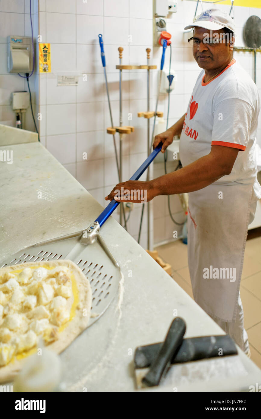 Florence, Italy October 15, 2016 Chef preparing pizza with burata
