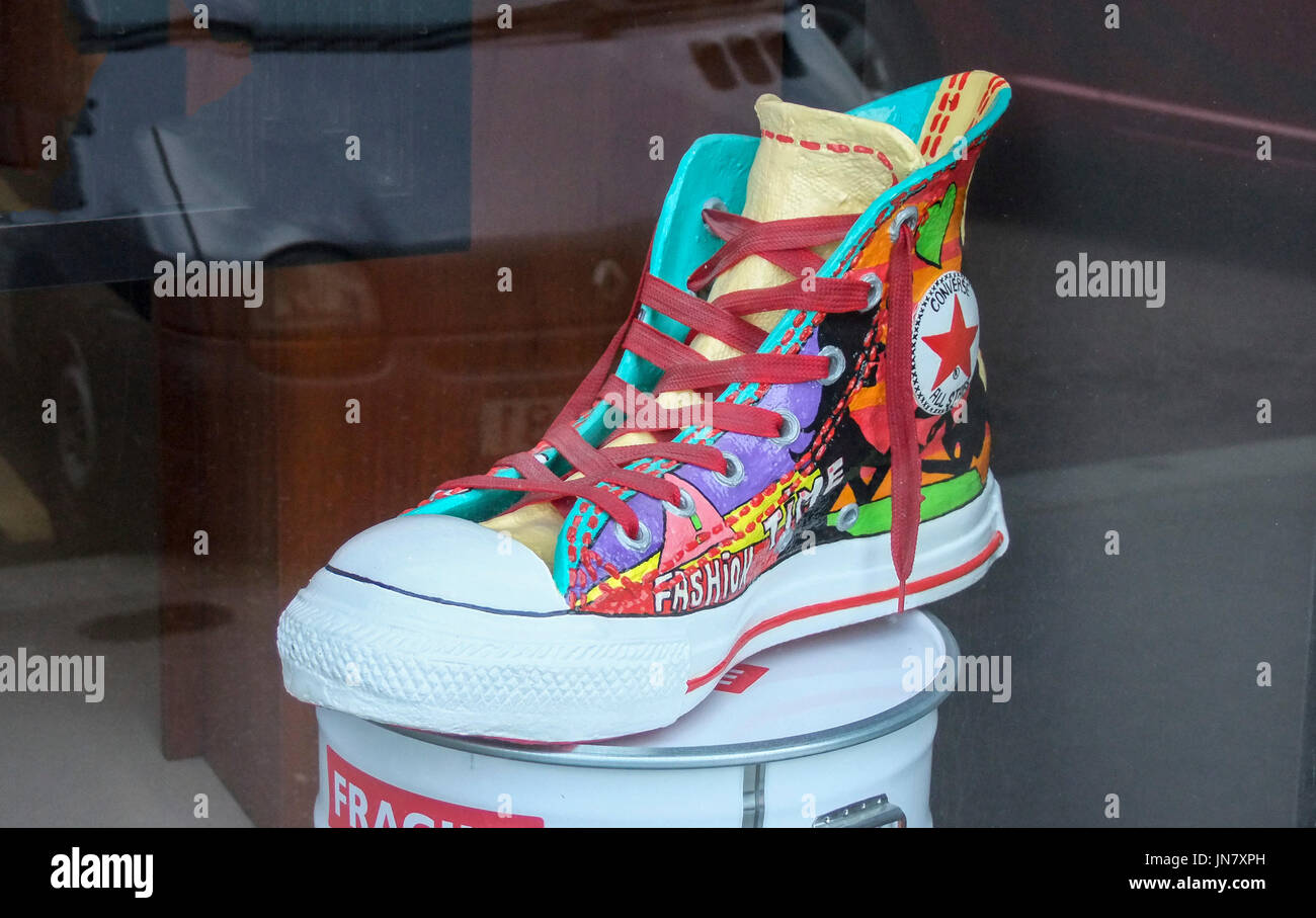 A colourful High Top All Star Converse trainer on display in a shop window  in Paris,France,Europe Stock Photo - Alamy