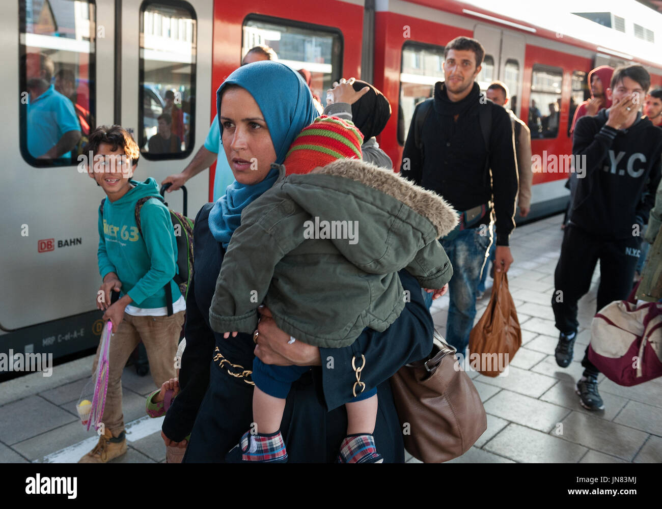 Munich, Germany - September 10th, 2015: Mother and daughter from Syria arriving in Munich. The refugees are seeking asylum in Europe. Stock Photo