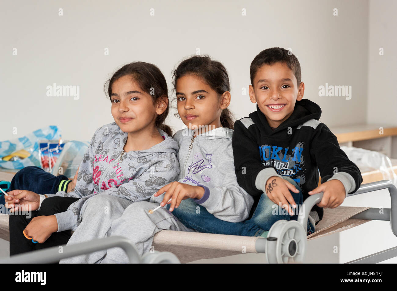 Passau, Germany - August 2th, 2015: Three sisters from Syria at a refugee camp in Passau, Germany. The refugee children are seeking asylum in Europe. Stock Photo