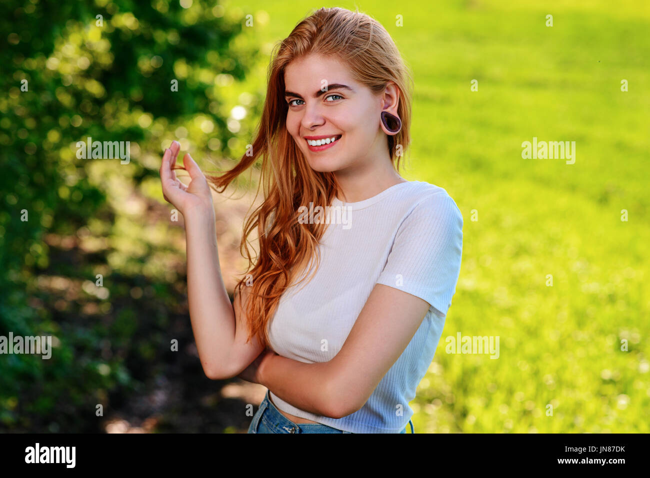 Portrait of a young beautiful woman with wooden tunnels in her ears