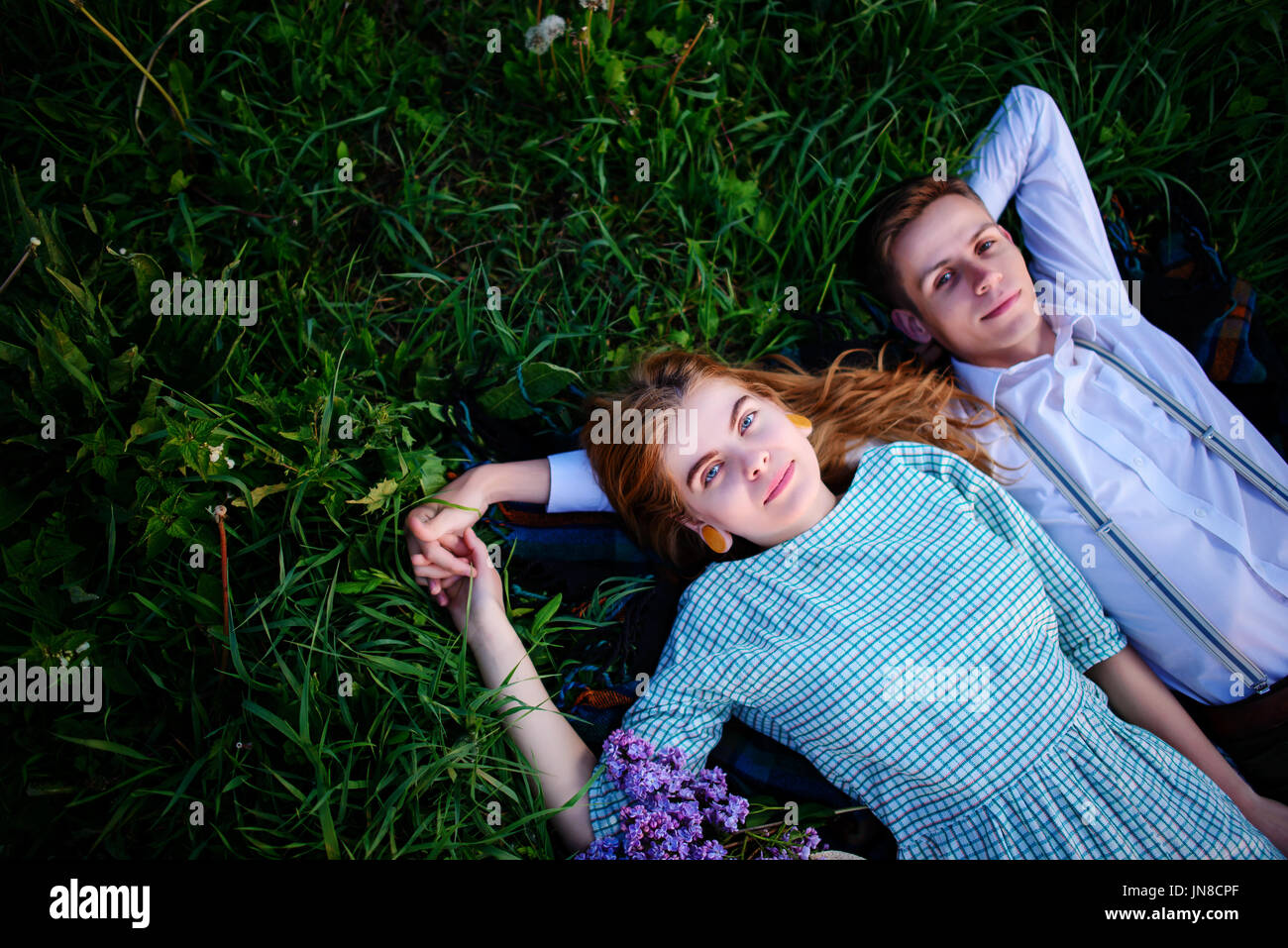 young couple lying on the grass and relax, view from above Stock Photo ...