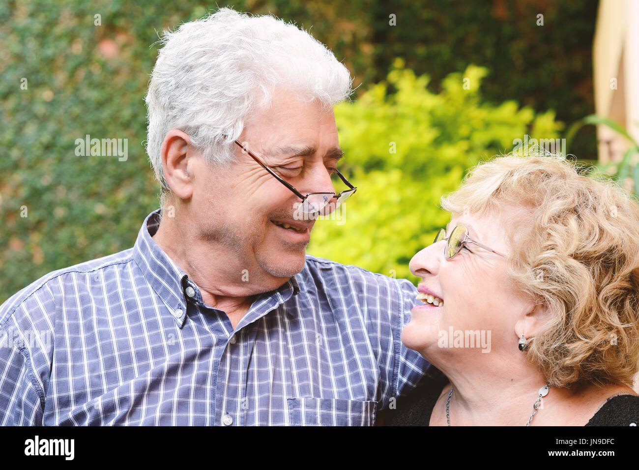 Portrait of an elderly couple sitting outdoors Stock Photo - Alamy