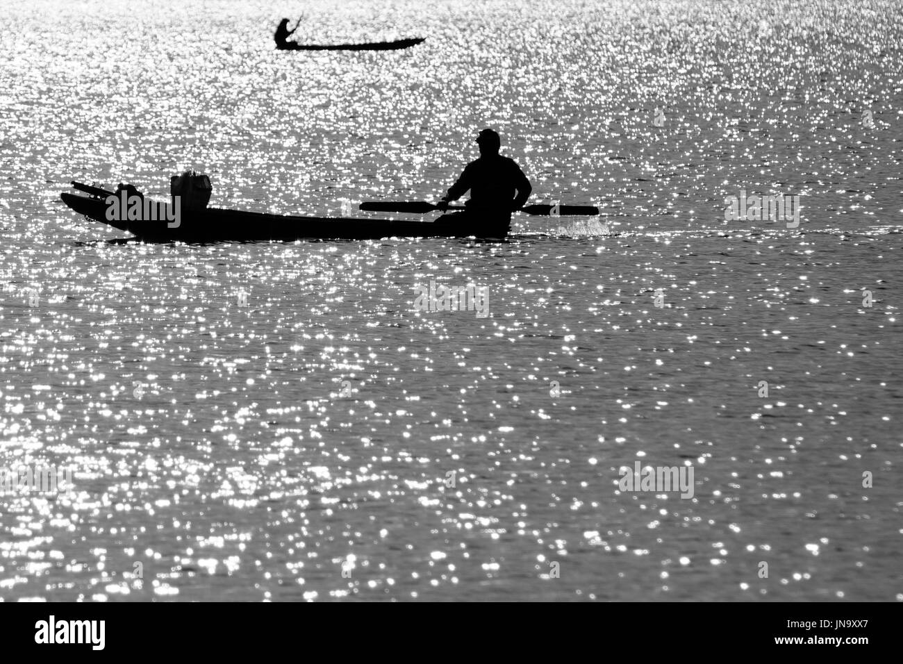 Boat fisherman sunset in Black and White Stock Photos & Images - Alamy