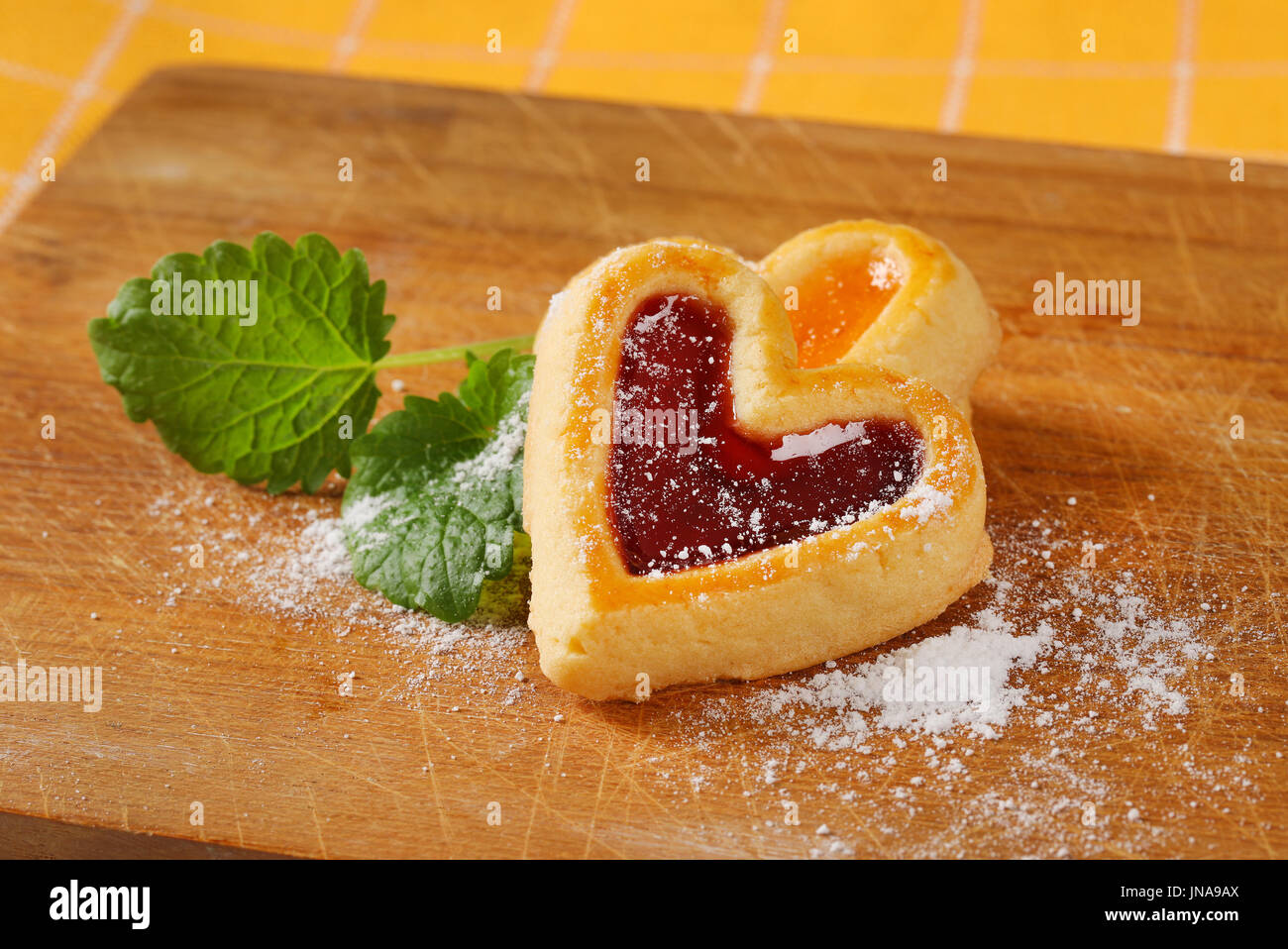 Heart shaped shortbread cookies with apricot and cherry jam filling