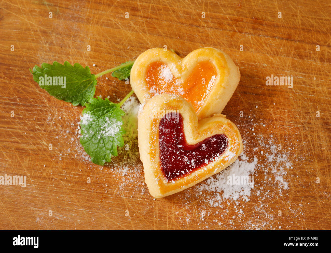 Heart shaped shortbread cookies with apricot and cherry jam filling