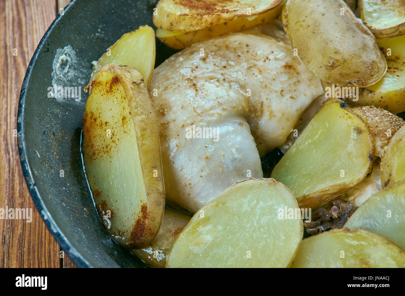Roasted Duck Legs and Potatoes a frying pan - Duck confit Stock Photo