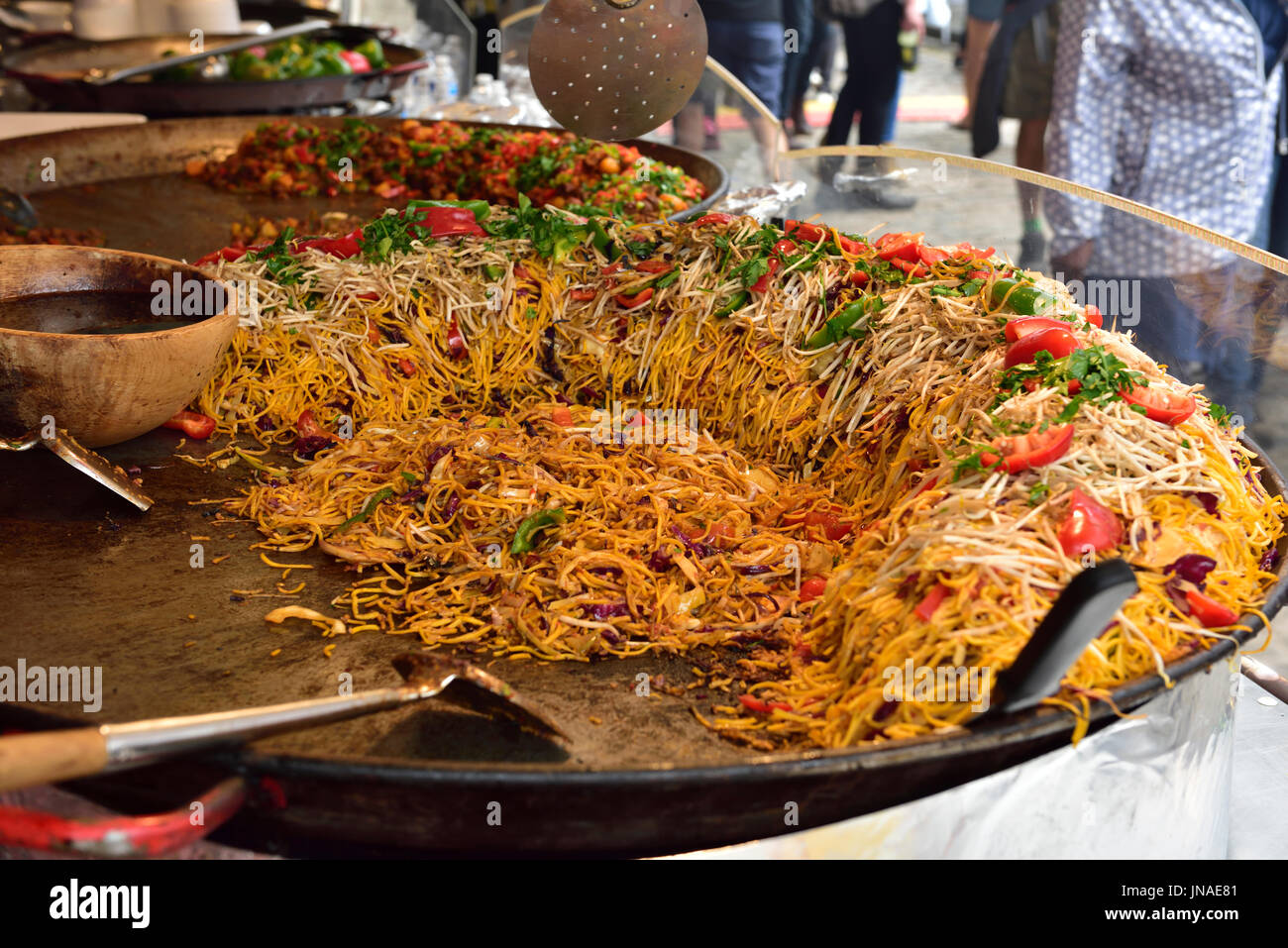 Large wok noodles stir-fry outside at festival Stock Photo