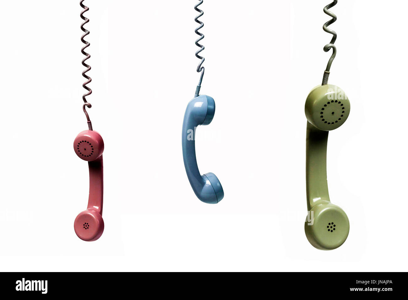 Three phones hanging from several colors isolated on a white background Stock Photo
