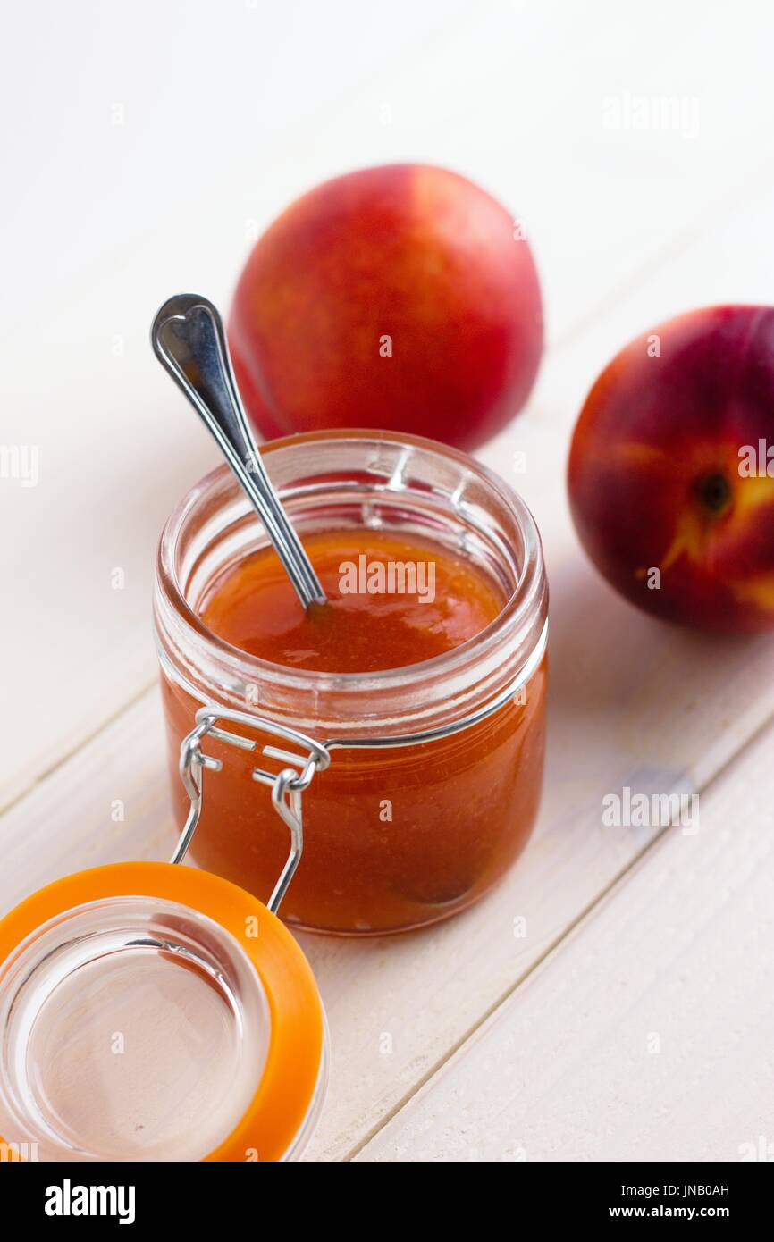 Download Peach Jam In Open Glass Jar With Two Peaches On White Background Stock Photo Alamy PSD Mockup Templates