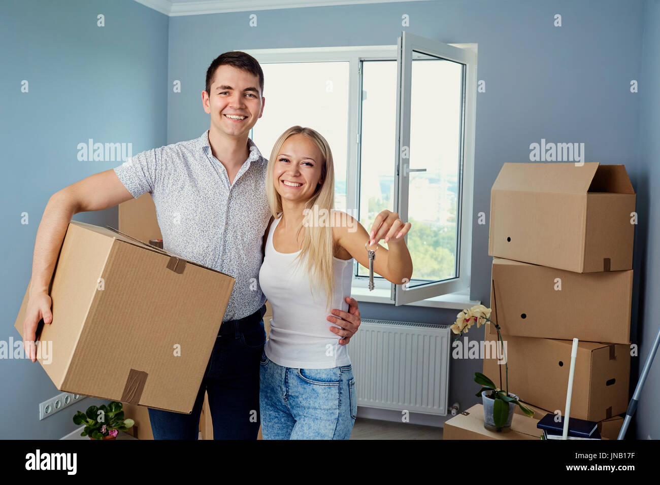 Young couple with keys in new housing Stock Photo - Alamy