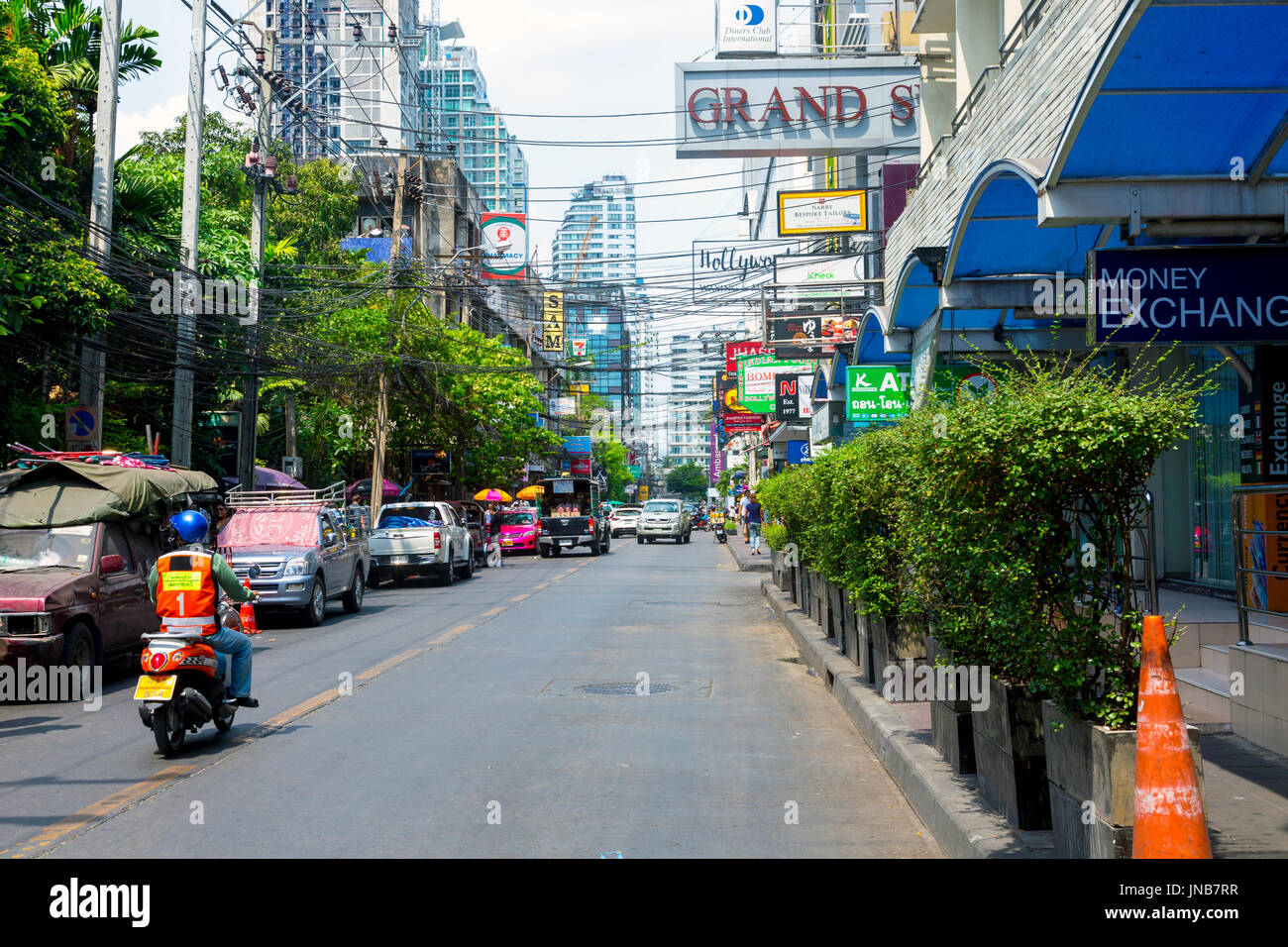 Man on a scooter in Sukhumvit area of Bangkok, Thailand Stock Photo