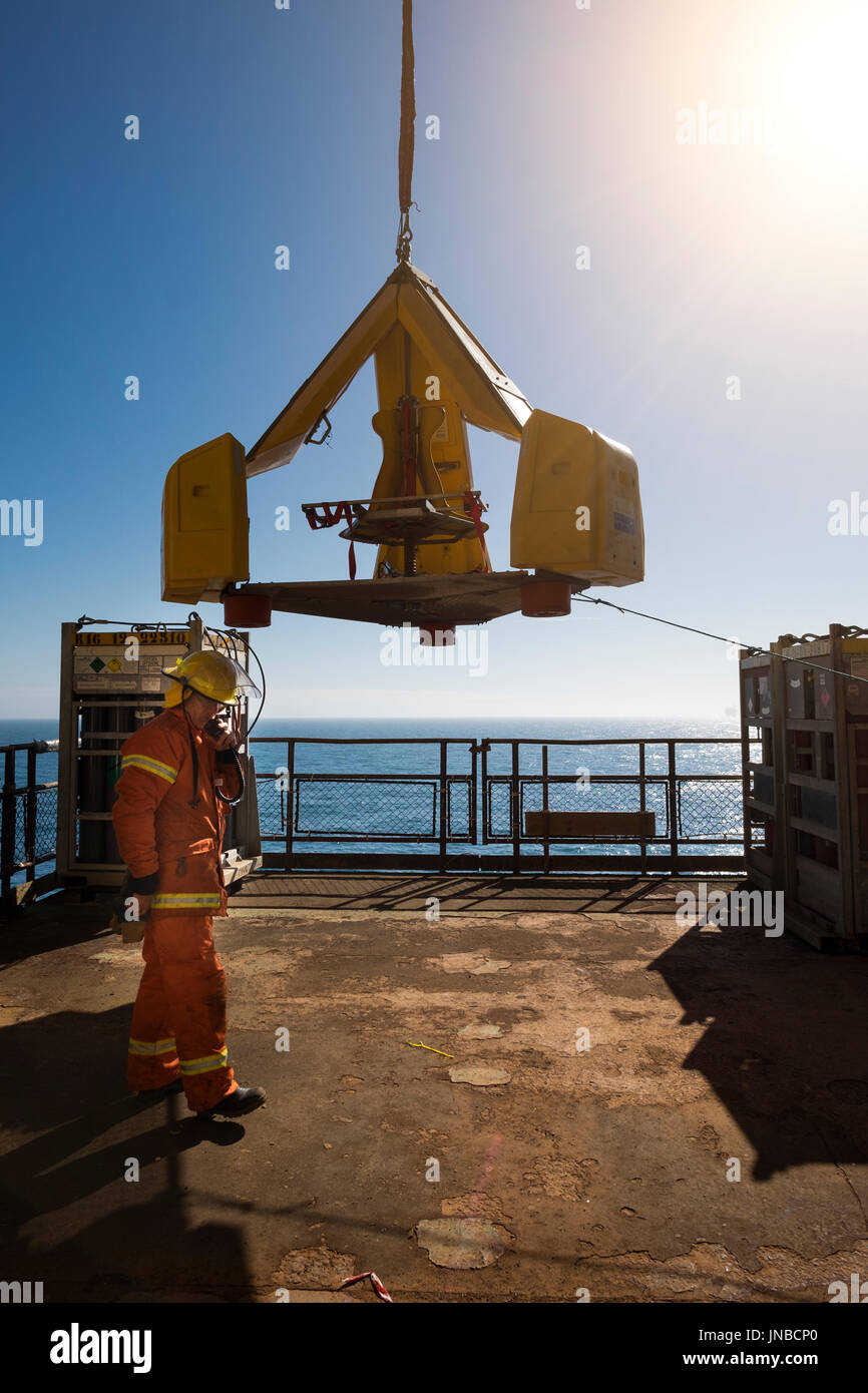 Fire team on north sea oil gas rig, practicing weekly emergency response drills. Utilising the frog. credit: LEE RAMSDEN / ALAMY Stock Photo