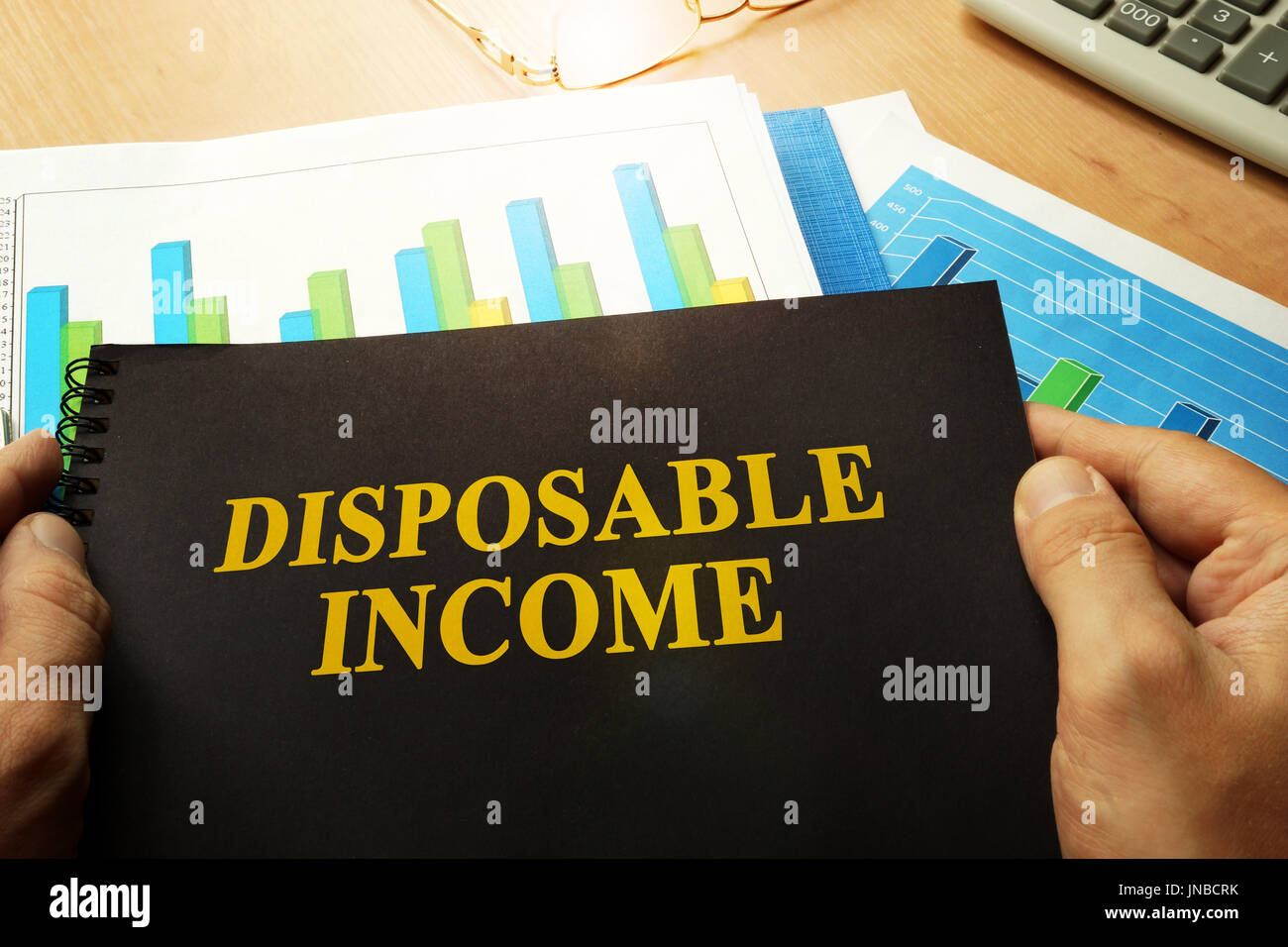 Disposable income written on a front of note. Stock Photo