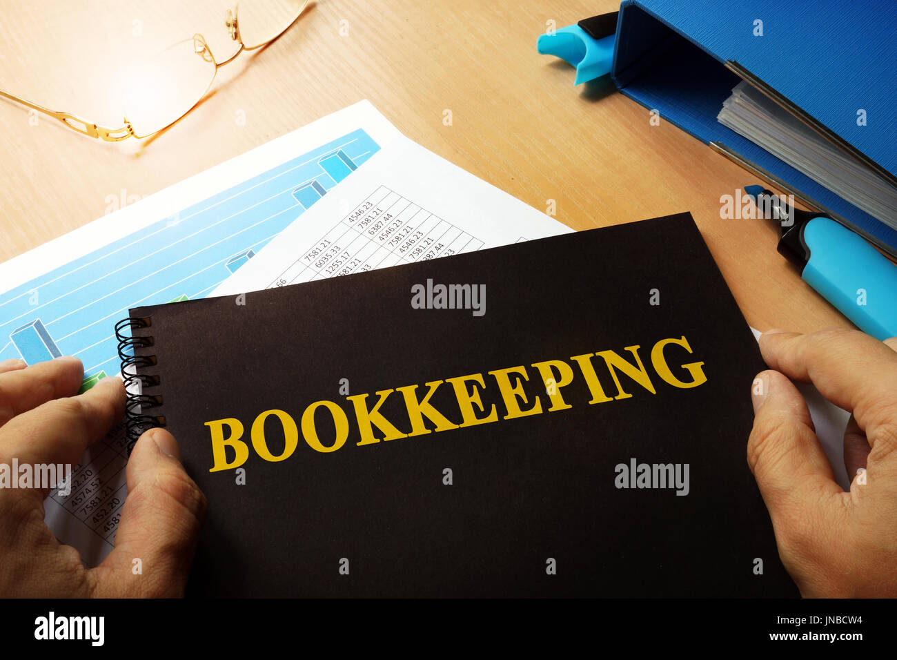 Bookkeeping written on a front of note. Stock Photo