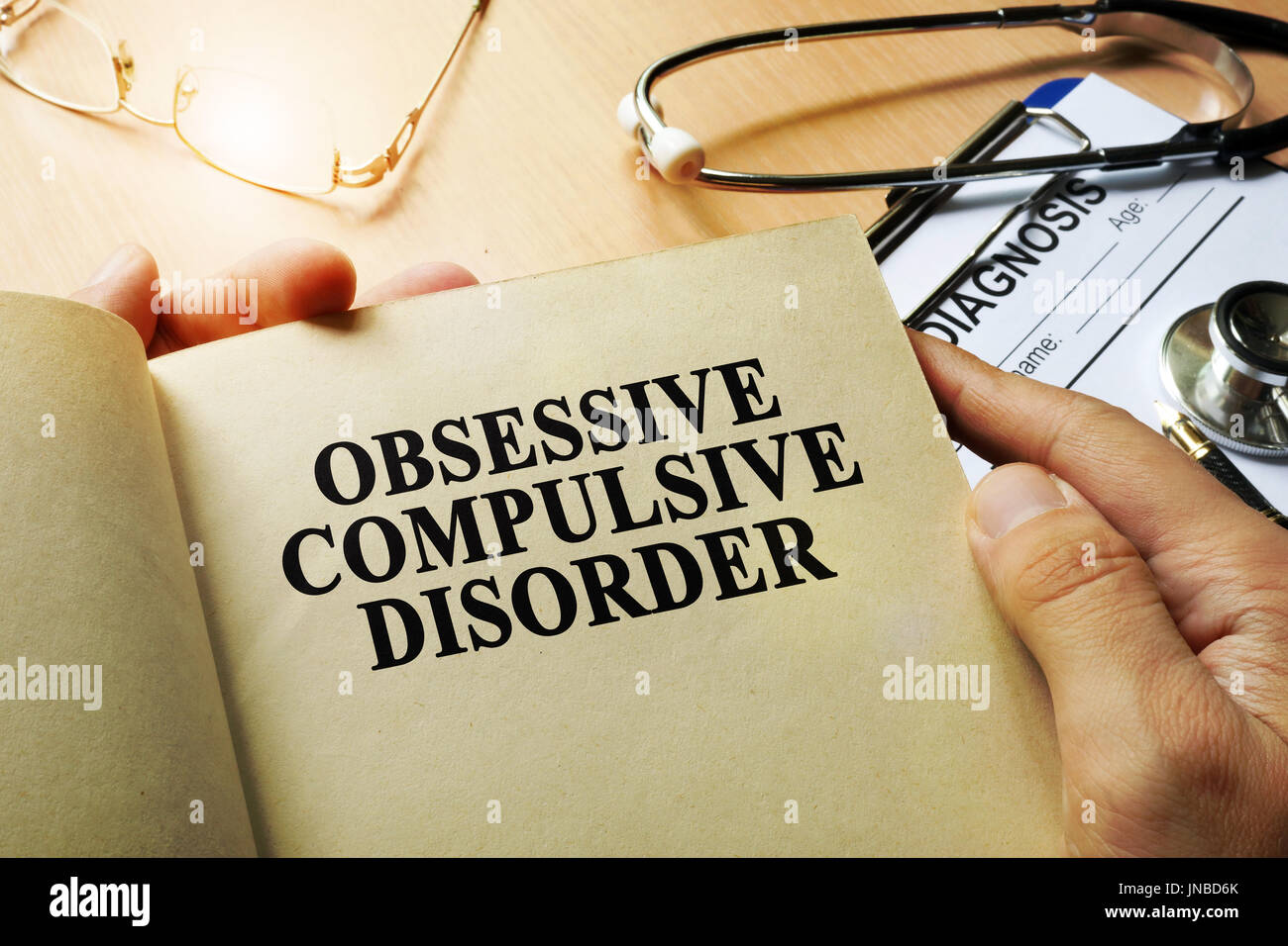 Obsessive compulsive disorder concept. Book on a table. Stock Photo