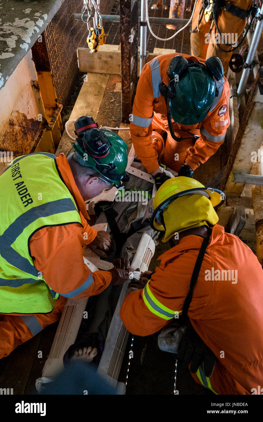 A first aider in orange coveralls / overalls, fireman and medic on an emergency response exercise. credit: LEE RAMSDEN / ALAMY Stock Photo