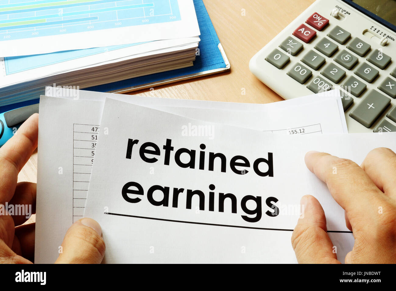 Papers with title retained earnings. Stock Photo