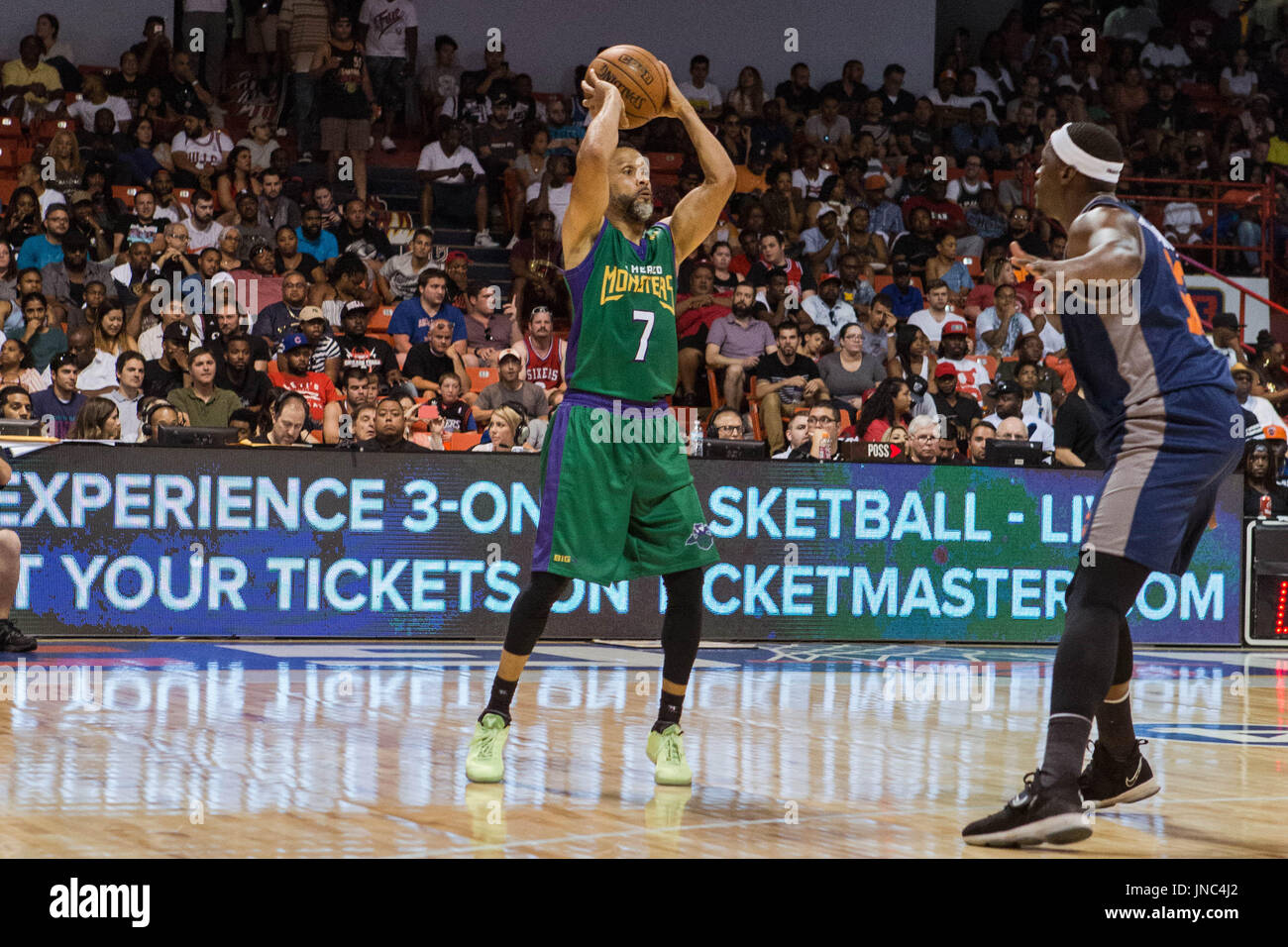 Mahmoud Abdul-Rauf #7 3 Headed Monsters raises ball above his head looking to pass to teammate as Al Thornton #12 3's Company guards him during Game #3 Big3 Week 5 3-on-3 tournament UIC Pavilion July 23,2017 Chicago,Illinois. Stock Photo