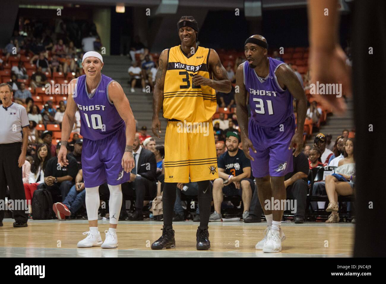 Eddie Robinson #32 Killer 3s smiles while standing between Captain Mike Bibby #10 co-captain Ricky Davis #31 Ghost Ballers along free throw line during Game #4 Big3 Week 5 3-on-3 tournament UIC Pavilion July 23,2017 Chicago,Illinois. Stock Photo