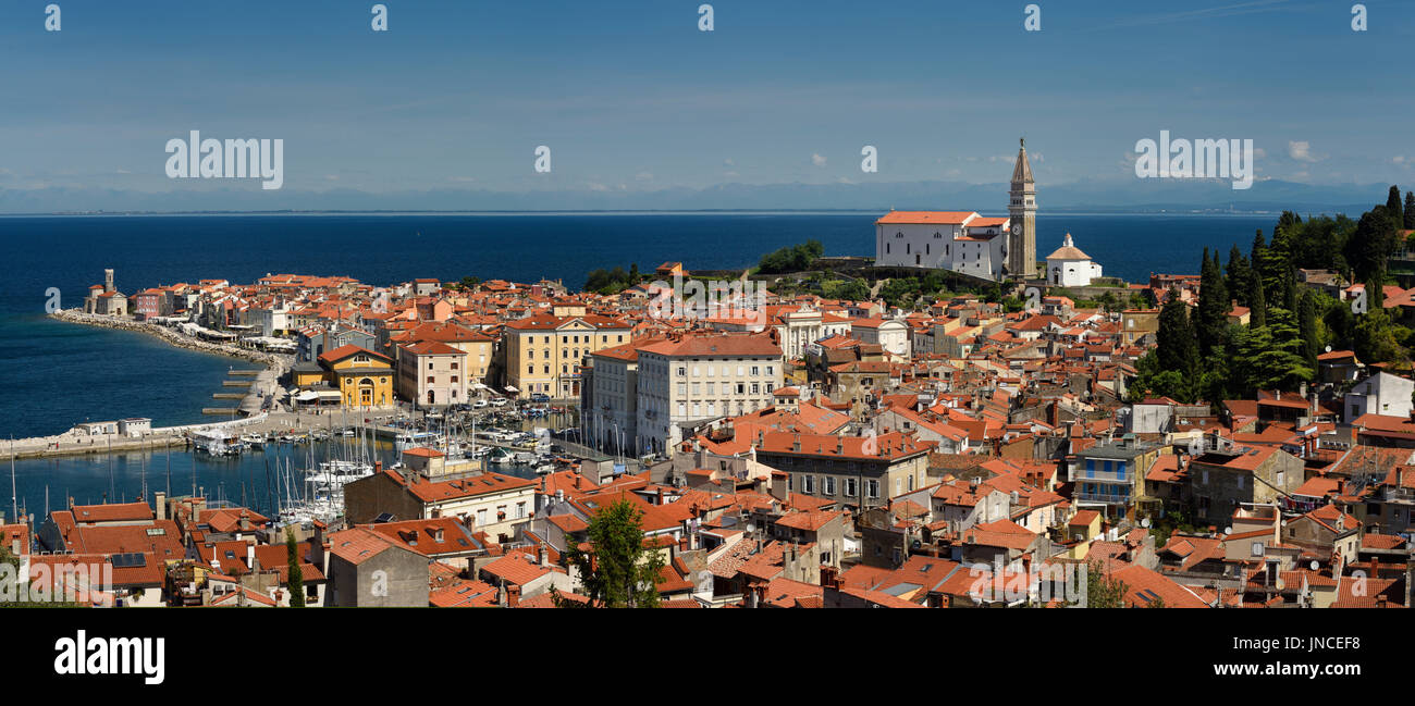 Panorama of Piran Slovenia on Gulf of Trieste Adriatic sea from the Cape Madonna St Clement church to St George's Cathedral with Kanin Mountains Stock Photo