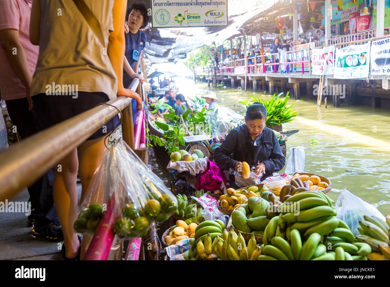 Woman selling fruit from a boat at Khlong Lat Mayom Floating Market, Bangkok Thailand Stock Photo