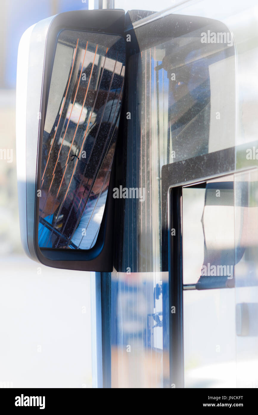 Reflected image from the mirror of a bus Stock Photo
