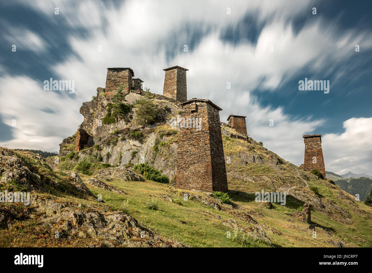 Medieval fortress Keselo in village Omalo in Tusheti, Georgia. Stone towers with blue sky and clouds taken by long exposure. Stock Photo