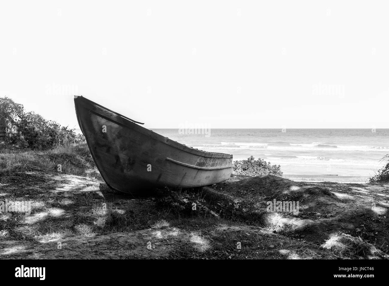 Old abandoned fishing boat on coast Stock Photo