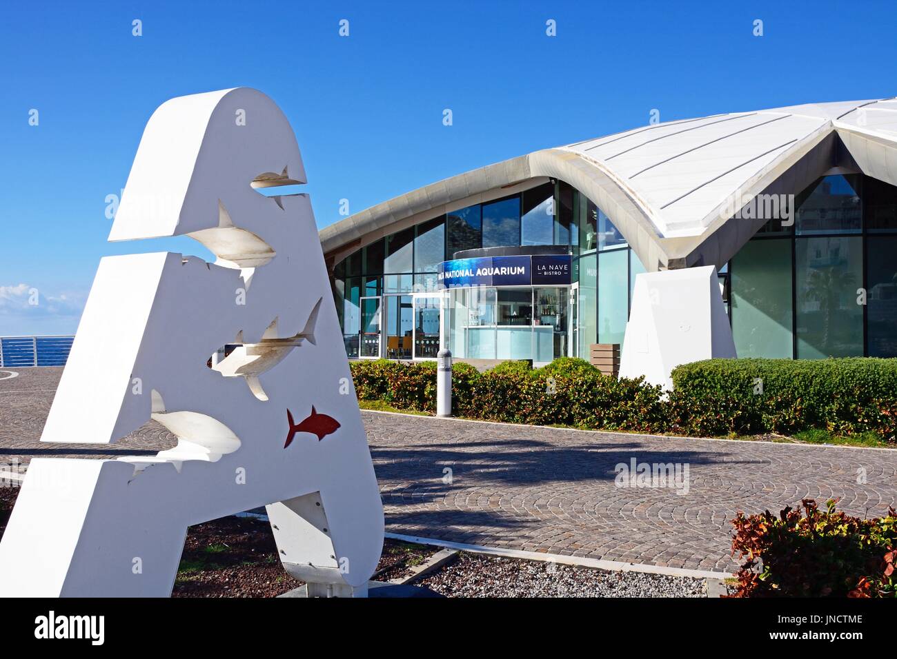 View of National Aquarium in St Pauls Bay with a letter A containing fish sign in the foreground, Bugibba, Malta, Europe. Stock Photo