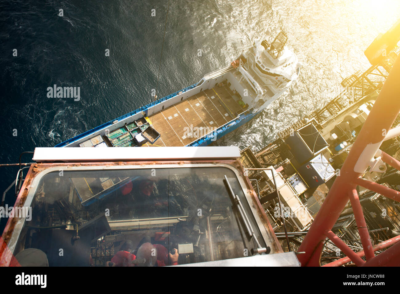 A colour image of a North sea oil and gas industry, Crane taking off supplies from the supply vessel. credit: LEE RAMSDEN / ALAMY Stock Photo