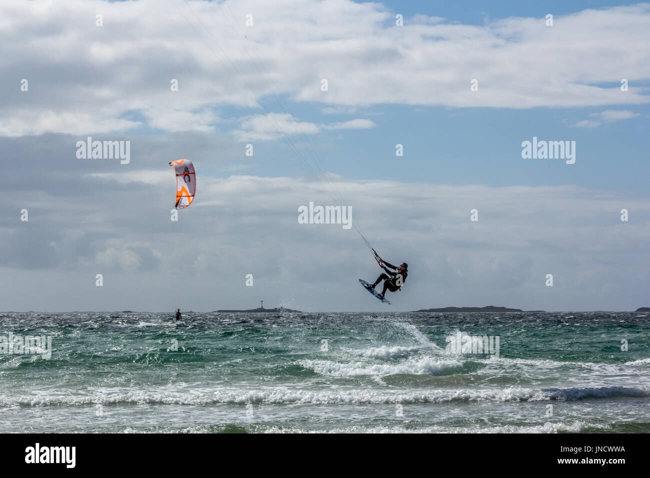 Kiting at Sola beach in south-west Norway summer of 2017. Beautiful mile -ong sandy beach when windy becomes kitesurfers paradise. Stock Photo